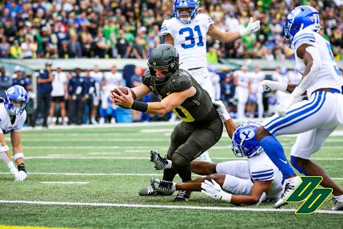 Oregon Ducks quarterback Bo Nix extends for a touchdown against the BYU Cougars at Autzen Stadium in Eugene, Oregon.